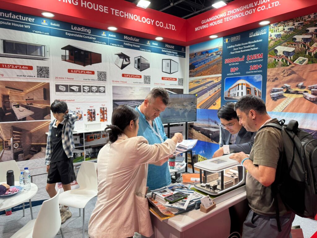 Atlas Career Global representatives inspecting a home model display at the China Homelife Expo
